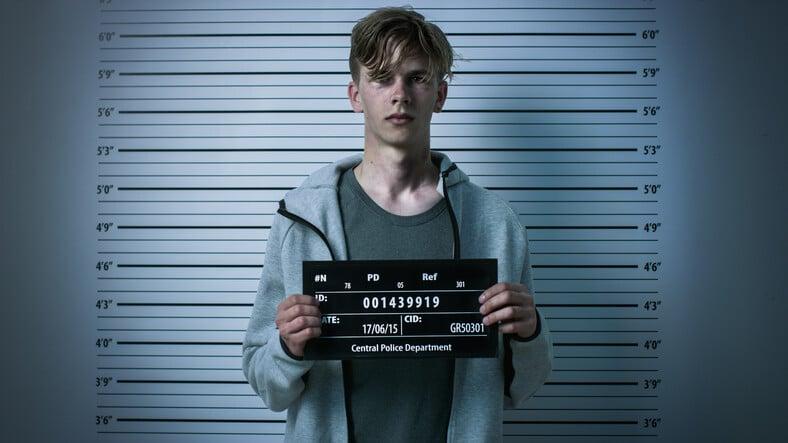 In a Police Station Arrested Drug Addict Teenage Posing for a Front View Mugshot. He Needs A Law Firm.