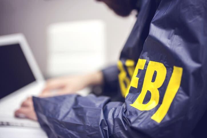 FBI agent working on his computer in office