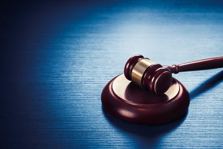 high contrast image of Judge gavel on a blue wooden background