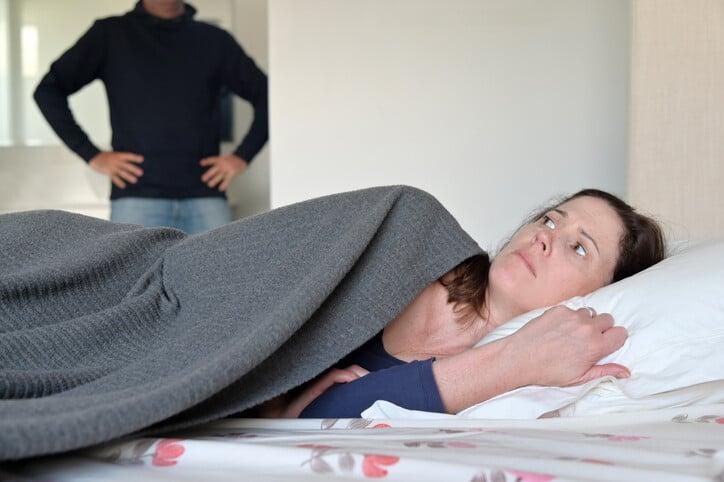 Adult woman lying down on a bed