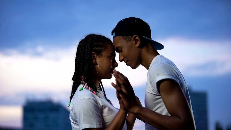 Teenage couple putting foreheads together