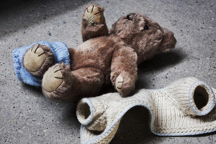 Stripped teddy on concrete floor