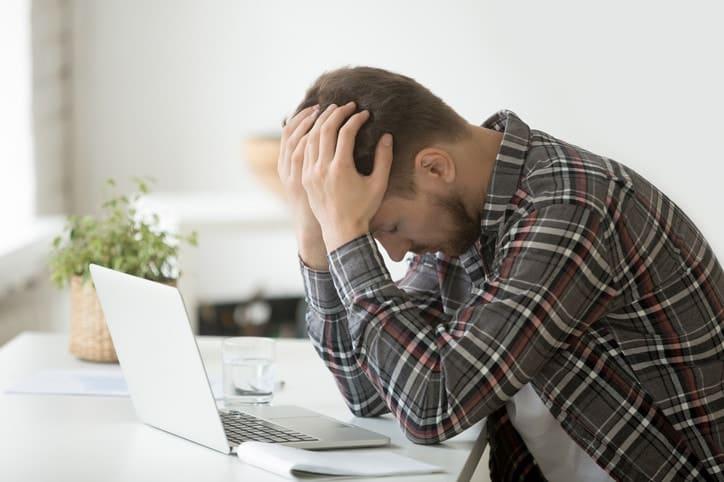 Frustrated depressed man shocked by online bankruptcy or stock downfall
