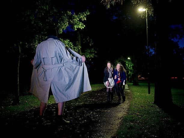 Two women laughing at a Flasher at night in the park sex offender