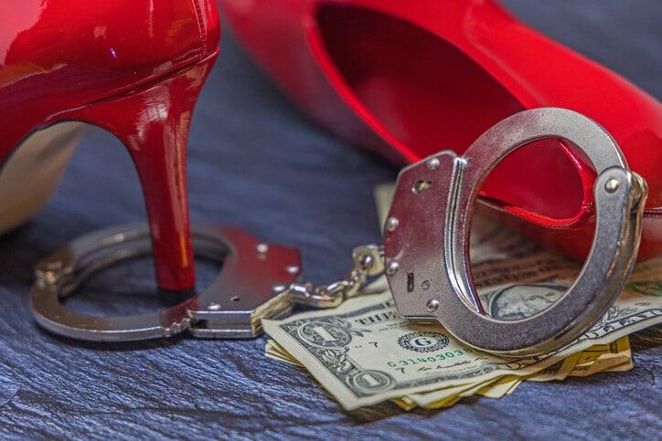 red shoes, metal handcuffs and dollar